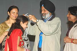 Dr Jai Rup Singh, vice-chancellor, Guru Nanak Dev University, honours a student during the prize distribution function of Apeejay College of Fine Arts in Jalandhar on Tuesday.