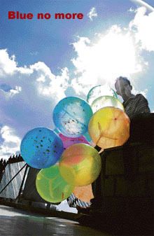 As the rays of the sun light up the feathery clouds up there, this balloon seller gives stiff competition to the colours of spring!