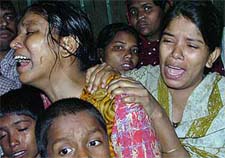 Bangladeshi mourners grieve after a fire swept through a slum in Chittagong on Tuesday.