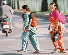 Mothers at work: Like any other routine day, women carry their children, unmindful that March 8 is Interenational Women’s Day