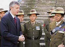 Britain's defence minister Derek Twigg speaks with Gurkha soldiers at Wellington Barracks in London on Thursday following a press conference where Twigg announced that Gurkhas would have the same pension as the British Army