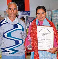 Chandrakala is all smiles as she poses with her father, Yadram Subedar, after receiving an award for her contribution to women empowerment.