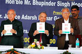 Chief Minister Bhupinder Singh Hooda and union law minister Hans Raj Bhardwaj release a book, Beti at a function in Kurukshetra 