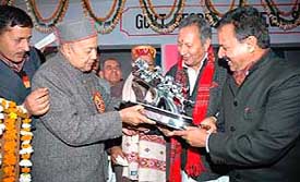 Himachal Chief Minister is honoured with a memento by Shahpur MLA Vijay Singh Mankotia (centre) at Sinhwa in Kangra district on Sunday.