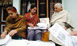 Nirmal Kour (in white shawl) and her daughters scanning letters, confirming the prescence of Assa Singh in a Pakistani jail