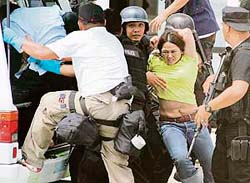 Special weapons and tactics policemen escort a woman who was taken hostage inside a courtroom in Suburban Taguig city of Manila