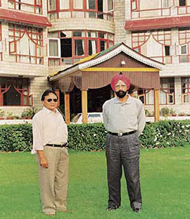 The writer (right) with Mr Brongpa, President of the Lahaul Potato Growers Society, in front of Hotel Chandramukhi which has been built by the society in Manali