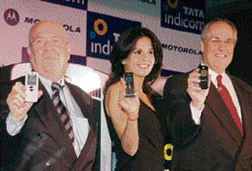 CEO of Tata Teleservices Limited Darryl Green (right) and vice-president and general manager of Motorola Inc. Malcolm G. Dawe along with a model at the launch of Motorola CDMA phones in New Delhi