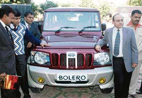 Gaurav Saxena, general manager, Mahindra and Mahindra (right), poses with the new Bolero during its launch in Chandigarh
