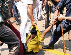 Police stamp on the stomach of a Youth Congress activist demonstrating in front of the North Gate of the State Assembly in Kolkata on Thursday 