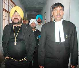 Pop star Daler Mehndi with his lawyer in Patiala on Thursday