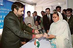 Minister of state for external affairs Anand Sharma hands over the first passport to a woman after inaugurating the passport office in Shimla on Friday