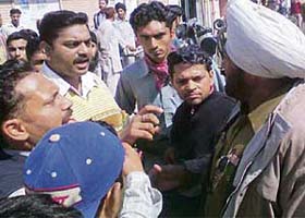 Agitators argue with a policeman outside an examination centre at Daulatpur Dhaki locality in Pathankot