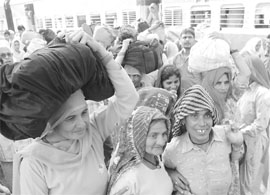 Pilgrims arrive in large numbers at Kurukshetra railway station on Sunday to take a dip in the sarovar on the occasion of a solar eclipse 