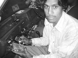Ram Kumar of Hisar displays the mobile phone-operated burglar alarm for cars that he has developed.