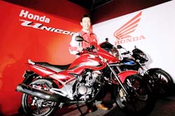 Chief executive officer and president, Honda Motorcycle and Scooter India (HMSI), Yukihiro Aoshima poses with the newly launched Unicorn motorcycle in New Delhi
