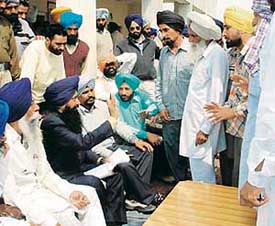 Sharanjit Singh Dhillon, MP and president, AIYADI, listens to the problems of the hailstorm-affected farmers at Jarg village in the Payal constituency on Monday. 