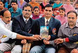 Members of the Akhil Bhartiya Uttarakhand Vikas Parishad with the book of Dr Vishnu Pandey released during a cultural event at Bal Bhavan in Sector 23, Chandigarh, on Tuesday.