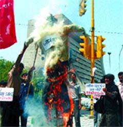 CPI(ML) activists burn the effigy of American President George Bush during a demonstration demanding withdrawal of troops from Iraq on the 4th anniversary of the US attack on Iraq, in the Capital