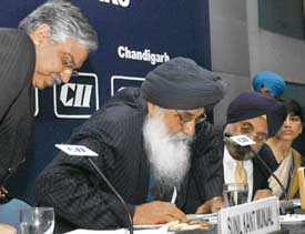 Chief Minister Parkash Singh Badal gets up to address industry delegates at a meet organized by the CII Punjab State Council at Chandigarh on Tuesday