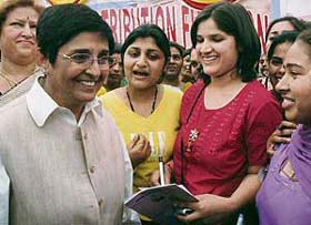 Kiran Bedi shares a light moment with students of Dev Samaj College for women, Chandigarh, during their annual prize distribution function held on the college premises