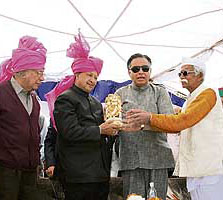 Chief Minister Virbhadra Singh is honoured by a veteran Congress worker at Rajiana village in the Nagrota Bagwan constituency on Thursday.