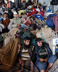 Stranded Kashmiri passengers rest at a bus stand in Jammu on Thursday. Thousands of Kashmiri passengers and hundreds of trucks loaded with essential commodities got stranded due to heavy landslides on the Jammu-Srinagar National Highway that remains closed for the 12th day.