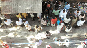 People gather outside the jewellery manufacturing unit.