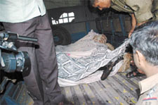 Charred remains of the workers being taken away.