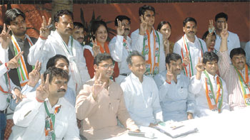 Senior Congress leader Ashok Galhot and National Youth Congress president Ashok Tanwar pose for a group photograph with the candidates contesting the MCD election. 