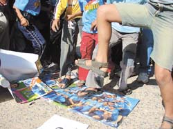 Cricket fans stamping on photographs of Indian cricket team players after their poor performance against Sri Lanka in the World Cup, in Gurgaon