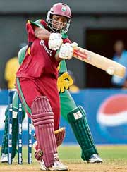 Shivnarine Chanderpaul of the West Indies hits a boundary on his way to a century during the Group D match against Ireland at the Sabina Park in Kingston on Friday. 