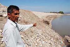 Nagar Chand Malhotra shows the sinking embankment at Tawi river.
