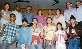 Students of Sanatan Vidya Mandir Senior Secondary School show off their prizes and trophies given them at an annual prize distribution function