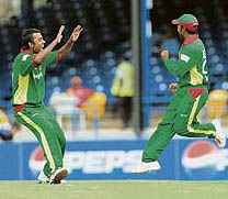 Bangladeshs Syed Rasel (left) celebrates with team-mate Aftab Ahmed after the dismissal of Bermudan batsman David Hemp at the Queens Park Oval in Port of Spain on Sunday.