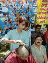 An angry cricket fan gets his head shaved in Allahabad on Monday as a protest against the Indian cricket teams pathetic performance in the World Cup.