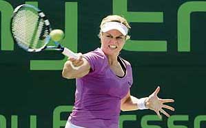 Kim Clijsters of Belgium returns to Australias Samantha Stosur during their third-round match of the Sony Ericsson Open at Crandon Park in Miami on Sunday. Clijsters won 6-4, 6-2. 