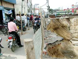 A huge trench dug up for construction of underground parking gets widened with earth sinking in and leaving very little space for passerby in front of Narinder Cinema in Jalandhar