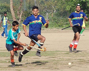 Players of 20 Lancers practise with the under-14 players of the the Karam Chand Thappar Hockey Academy at Sansarpur village near Jalandhar.