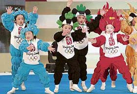 Young Chinese dancers wear the costumes of the Beijing 2008 Olympic Games mascots as they perform during the medal launching ceremony in Beijing