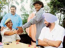 Bimal Kumar Sharma finds himself handcuffed by magician Mohammad Ishaq while DSP Malerkotla Rachhpal Singh Hara looks on at a police station in Ahmedgarh