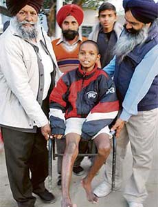 Owners of a cycle stand carry Sonu at Government Rajindra Hospital in Patiala