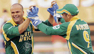 South Africas Charl Langeveldt and Mark Boucher celebrate the dismissal of Sri Lankas Mahela Jayawardene during their Super Eight match in Georgetown, Guyana.