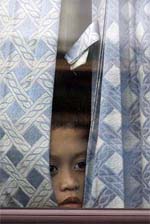 A child looks out of a window of a bus while being held hostage in Manila on Wednesday.