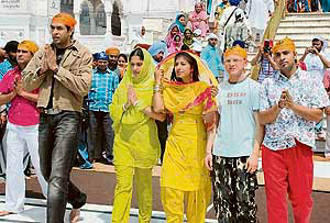 The cast of Punjabi film Lakh Pardesi Hoie during the shooting in the Golden Temple in Amritsar on Thursday. 