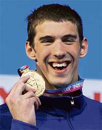 Michael Phelps of the US poses with his gold medal during the awards ceremony for the mens 200m individual medley final in Melbourne
