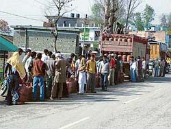As there is no home delivery of gas refills at most places in Mandi district, consumers await their turn for refills at Ner Chowk near Mandi