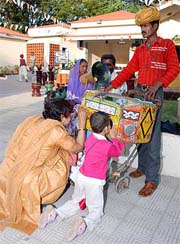 Remembering old times: A woman and her son enjoy viewing a bioscope at Oasis Kraft Mela, Karnal, on Friday