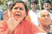 Bhartiya Janshakti Party national president Uma Bharti addressing a press conference on MCD polls in the Capital on Saturday, as former Delhi Chief Minister Madan Lal Khurana looks on. 