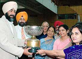 Punjab finance minister Manpreet Badal gives away the trophy to the winners at the annual sports function of Panjab University in Chandigarh on Saturday.